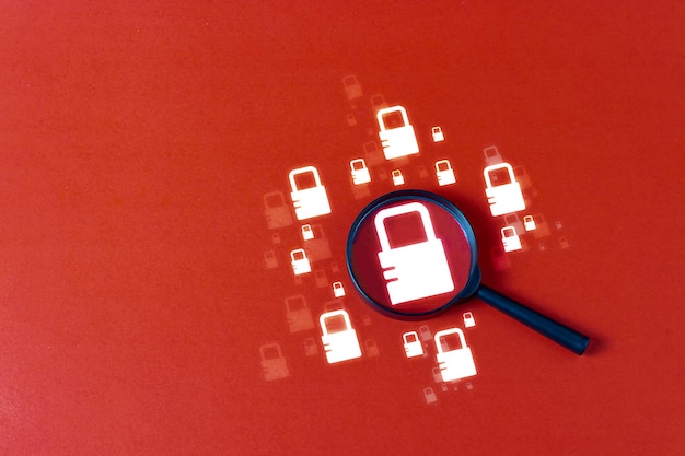 Security search uses a magnifying glass Security key System weaknesses and massive connection information and antihacker on a red background