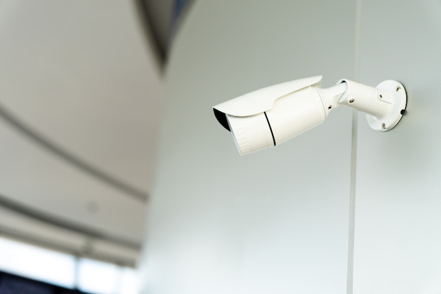 Security white CCTV (Closed-circuit television) camera in the office building