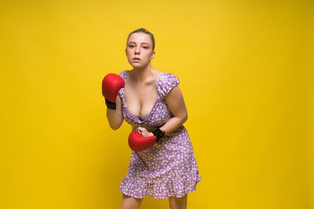 Seductive confident female boxer with gloves studio sporty woman posing looking at camera