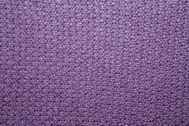 Seed stitch in lilac yarn as an abstract background texture