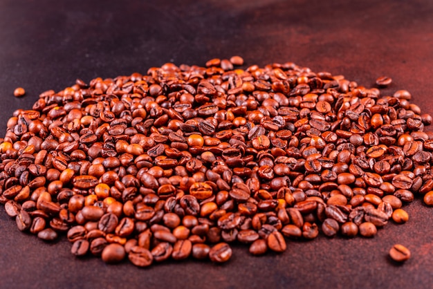 Seeds of fragrant coffee on a dark concrete background. It can be used as a background