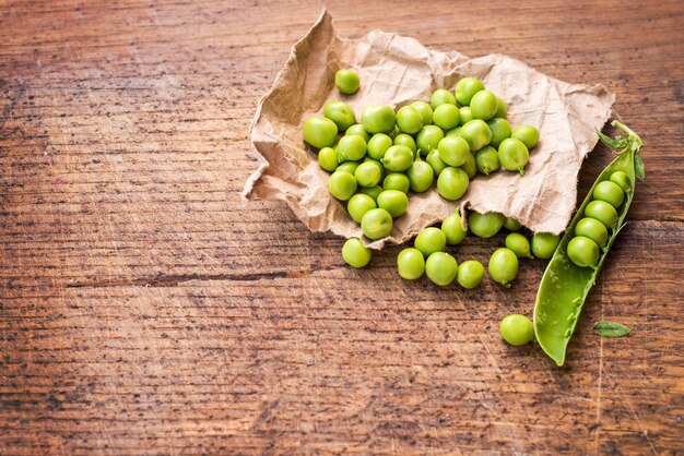 A seeds of peas on wooden background