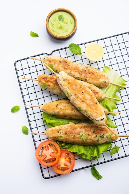 Seekh Kabab made with minced chicken or Mutton keema, served with green chutney and salad