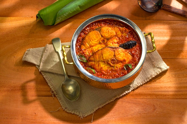 Seer Fish curry traditional Indian fish curry Kerala special arranged in a copper serving bowl