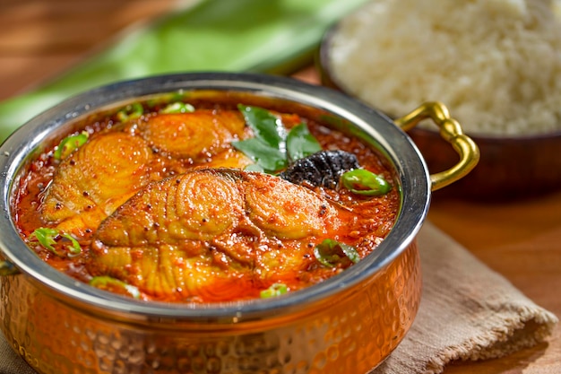 Seer Fish curry traditional Indian fish curry Kerala special arranged in a copper serving bowl