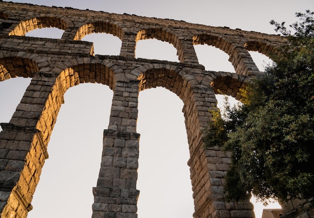 Segovia aqueduct at sunset from below looking up