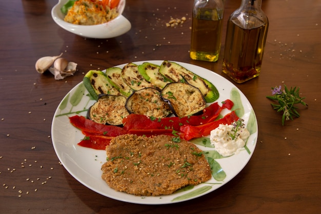 Seitan dried fruit pie with grilled vegetables. Healthy vegan food