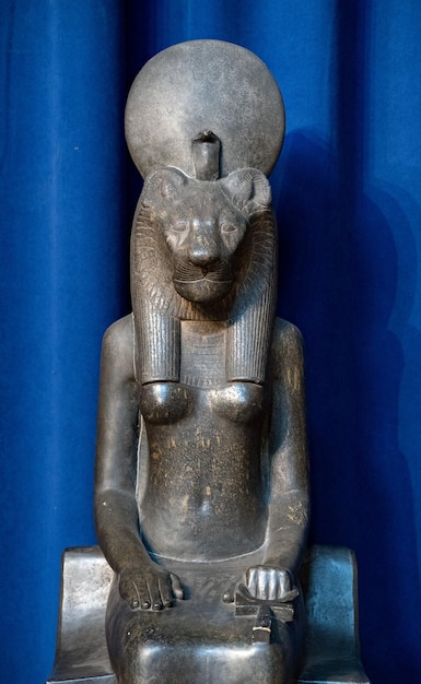Sekhmet goddess statue isolated on blue