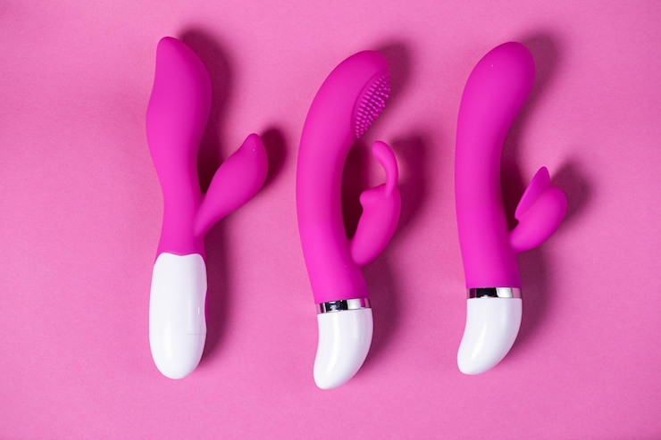 Foto seksspeeltjes paarse en roze vibrators geïsoleerd op een roze achtergrond