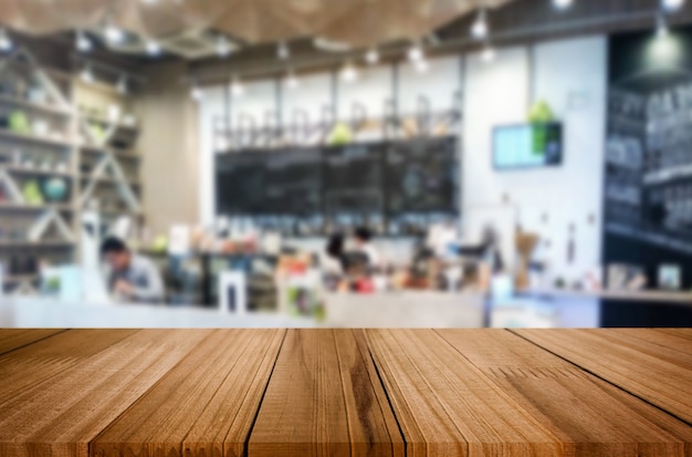 Selected focus empty brown wooden table and Coffee shop or restaurant