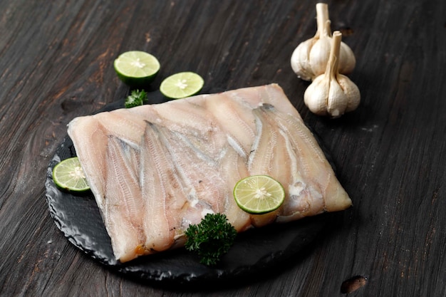 Selected Focus Frozen Catfish Fillet on Black Wooden Table