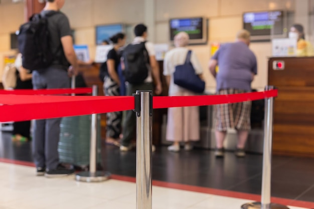 Selected focus on security post with passenger check in at the\
airport