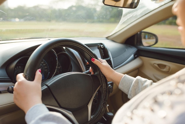 Selected focus Woman is hands on the steering wheel of the car