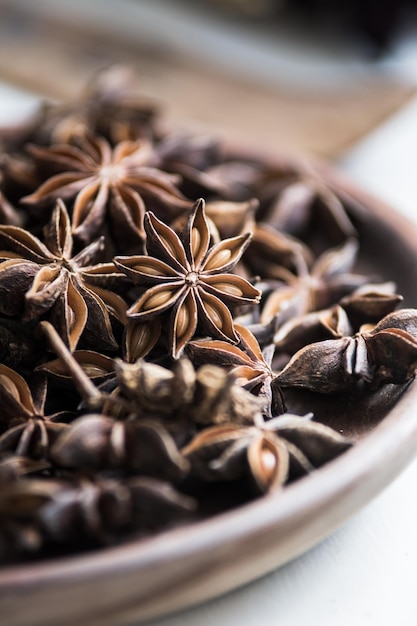 selected star anise stars on a wooden bowl