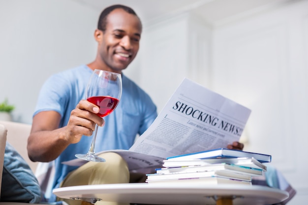 Selectieve aandacht van een glas wordt gevuld met rode wijn in handen van een leuke positieve ontspannen man