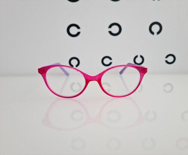 Selection of children trendy glasses on table of ophthalmologist in clinic