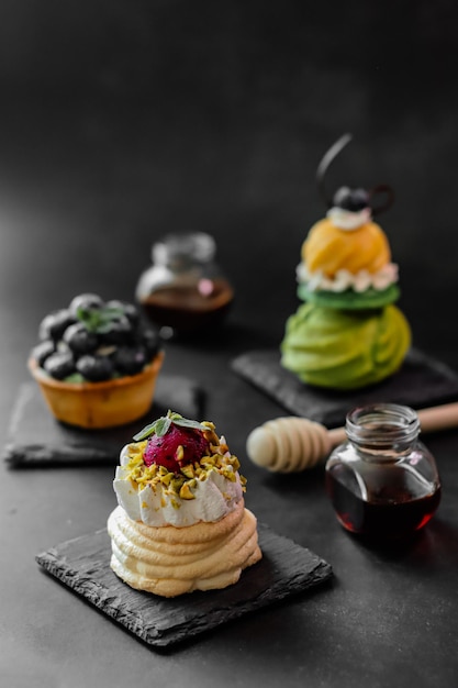 A selection of desserts on a black table