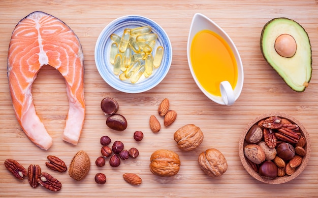 Selection food sources of omega 3 and unsaturated fats on wooden background.