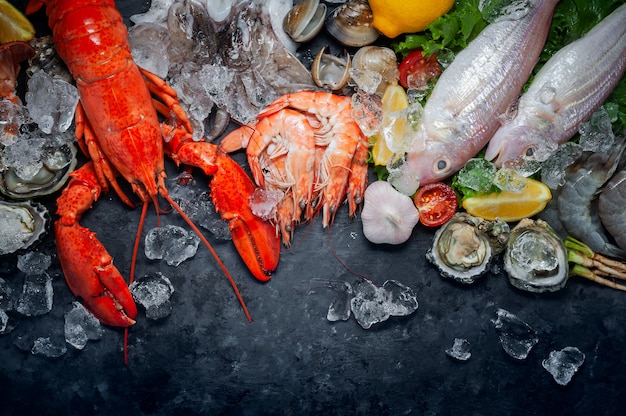 Photo selection of fresh lobster, shrimp, fish, oyster, squid and crab with lemon and ice cubes