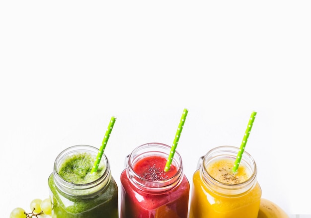 Photo selection of multicolored fruit smoothies in glass jars healthy food detox concept