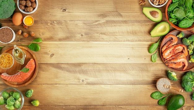 Selection of omega rich food sources on wooden background top view copy space