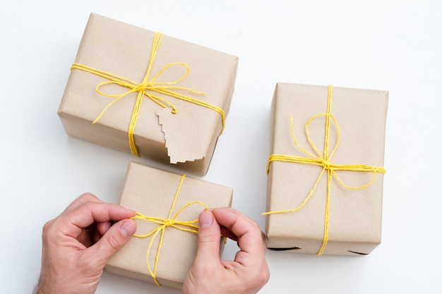 Selection of presents wrapped in craft paper tied with a yellow twine.