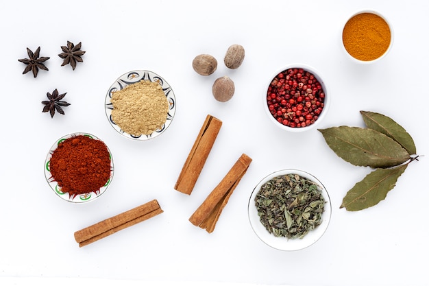 Selection of various species and herbs in bowl and spoons