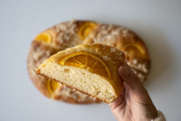 Selective approach to piece of roscÃ³n de reyes (three kings bread), white background, christmas sweets concept