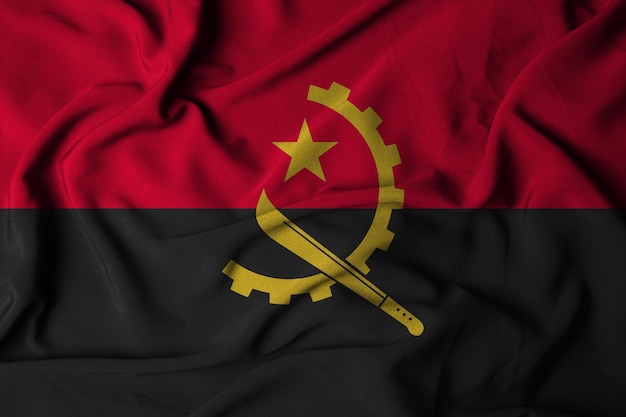 Foto messa a fuoco selettiva della bandiera dell'angola, con tessuto ondulato. illustrazione 3d