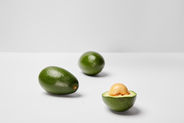 Selective focus of avocados on grey background