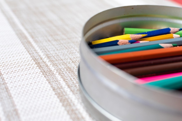 Selective focus of a can full of colored pencils