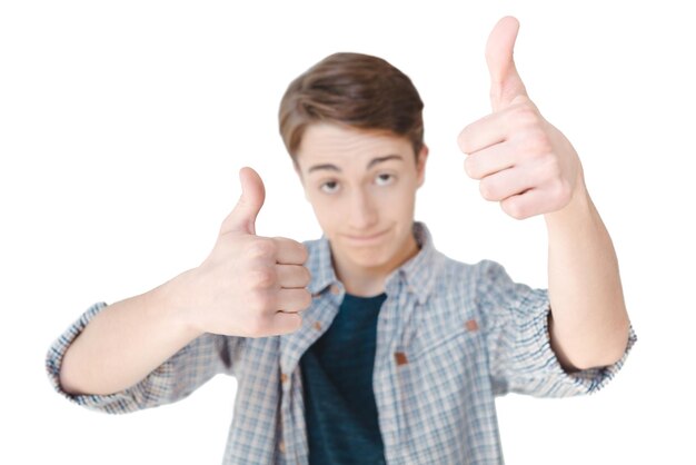 Selective focus of caucasian teenager showing thumbs up isolated on white