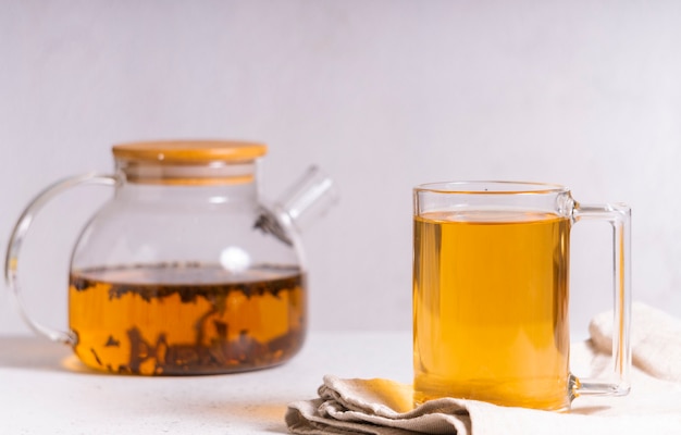 Selective focus: ceylon black tea in a transparent mug on a light table copyspace. horizontal position. minimalistic style