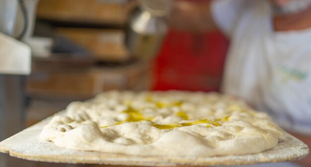 Selective focus on closeup of traditional roman pizza ready to bake
