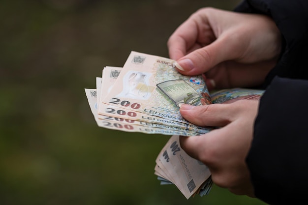 Selective focus on detail of LEI banknotes. Counting or giving Romanian LEI banknotes. World money concept, inflation and economy concept