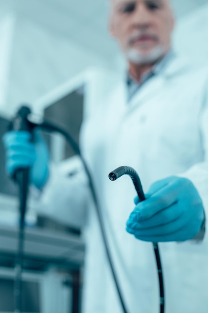 Selective focus of an endoscope in hand of a doctor stock photo