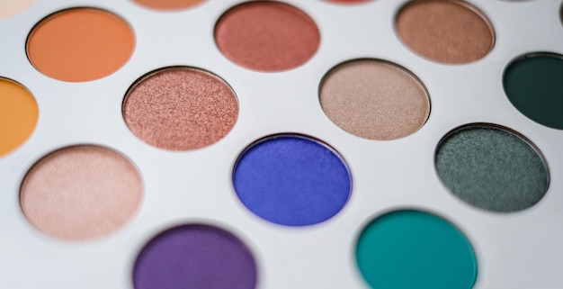 Selective focus of eyeshadow palette with various colors in pearly and matte closeup