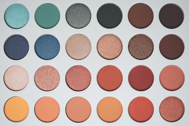 Selective focus of eyeshadow palette with various colors in pearly and matte closeup