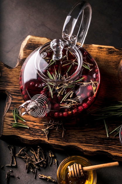 Selective focus, freshly brewed tea in a transparent teapot, with fruits and fresh berries. leaf tea and spices. still-life. for advertising and menus