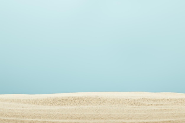 Selective focus of golden and textured sandy beach isolated on blue