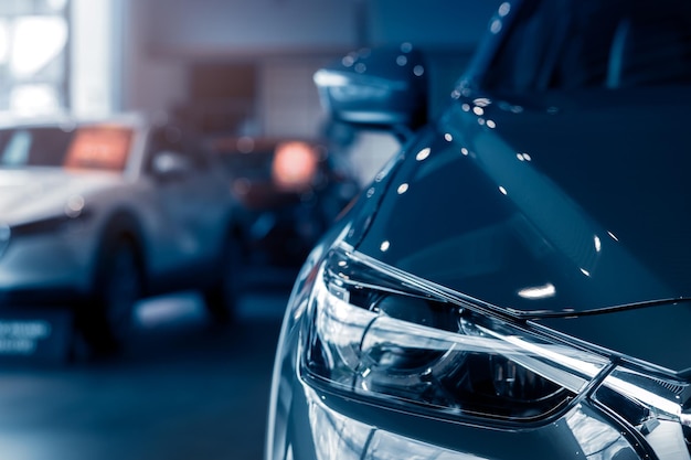 Selective focus grey car parked in luxury showroom car dealership office new car parked