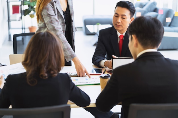 Selective focus hand of business woman pointing on paperwork in meeting room