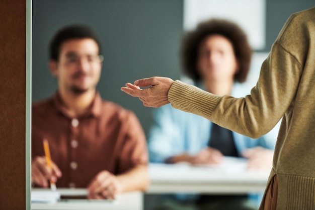 Selective focus on hand of mature teacher or speaker