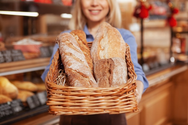 Selective focus on loafs of delicious fresh bread in a basket.