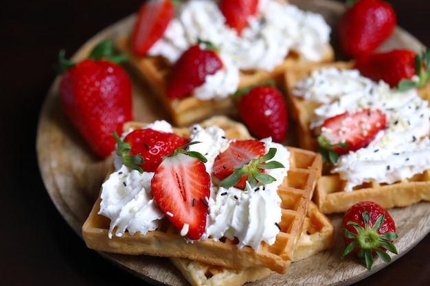 Selective focus Macro Belgian waffles with strawberries and cream