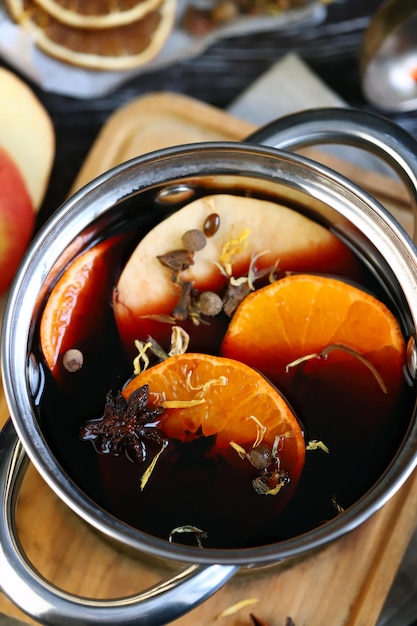 Selective focus. Mulled wine with citruses and red wine.