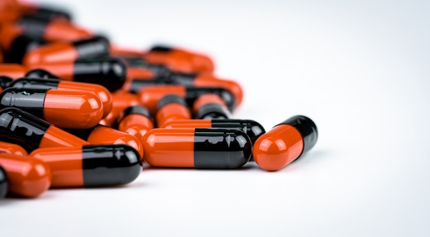 Selective focus on orange-black capsule pills. Antibiotics drug resistance. Drug use with reasonable. Antimicrobial capsule pills. Pharmaceutical industry.