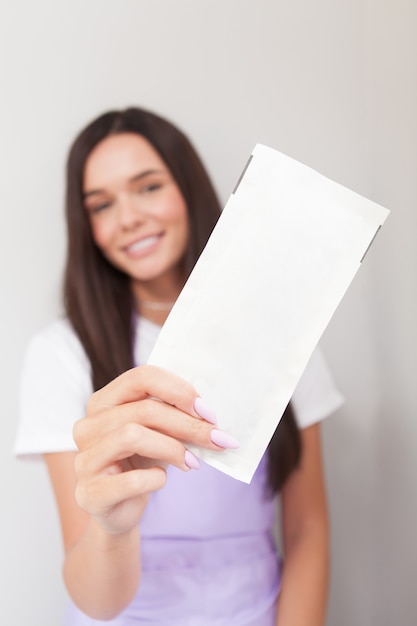 Selective focus on paper bag with sterilised in dry heat machine instruments in hand of manicurist