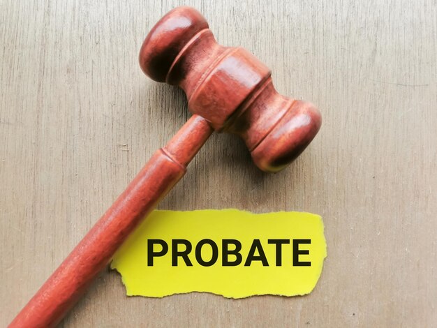 Selective focus phrase PROBATION written on yellow paper strip with gavel