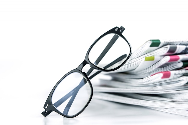 Selective focus on reading eyeglasses with stacking of newspaper